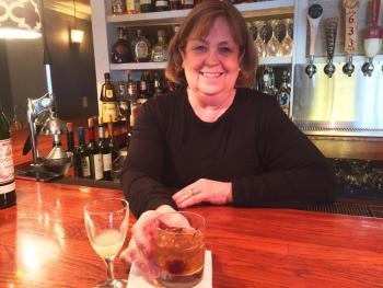 Marilyn Gorneau tends her bar at Little Village Bistro in Wiscasset. SUZI THAYER/Boothbay Register