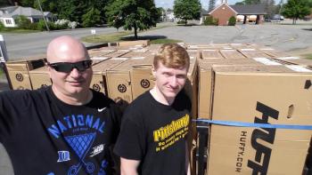 Stuart and Alex Smith get ready to assemble bikes for kids who read voraciously. Courtesy of Stuart Smith
