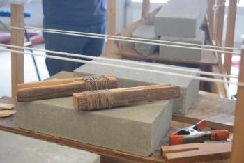 Wabanaki clamps made of cedar and deer hide side by side with their modern counterparts. Both ancient and modern tools have a role to play in the construction of a traditional birch bark canoe. Courtesy of DRA