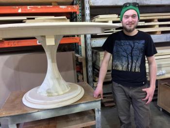 Christian Bassett was clearly pleased with a garden table he had just finished for Elkins & Co. SUZI THAYER/Boothbay Register