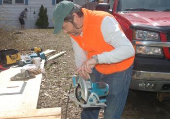 Oceanographer Barney Balch cuts a board for a deck repair. ART MAYERS/Boothbay Register
