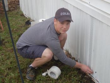 Henry Drapeau repairs damaged skirting. ART MAYERS/Boothbay Register