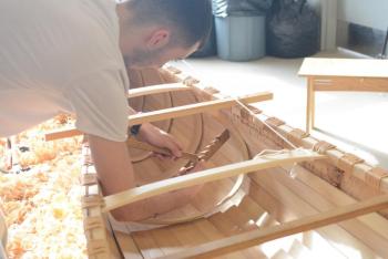 Intern Tobias Francis installs a rib on the Wabanaki birch bark canoe to be launched at the Damariscotta Town Landing on Thursday, April 27. The month-long canoe building project is the result of a partnership between Damariscotta River Association and Lincoln Academy, with support provided by LincolnHealth as well as members of the community. Courtesy photo