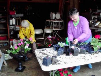 Two volunteer days are scheduled to help get the Boothbay Railway Village ready for the 2017 season. Sign up to help on April 29 or May 13 with tasks like raking leaves or stocking the Museum Store. Pictured here are volunteers Kevin Bowler, right, and Sarah Strouss planting flower boxes during a prior year’s work day. Courtesy photo