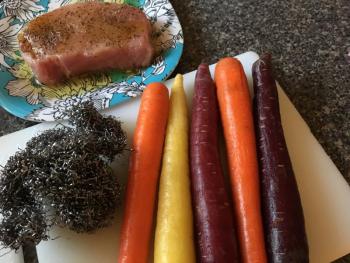 Colorful organic carrots get a scrubbing from a metal scrubber before roasting. SUZI THAYER/Boothbay Register