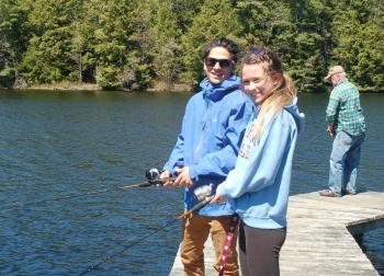 Stuart Salom and Ainsley Mullins cast for trout from the Boothbay Region Fish and Game Association dock. ART MAYERS/Boothbay Register