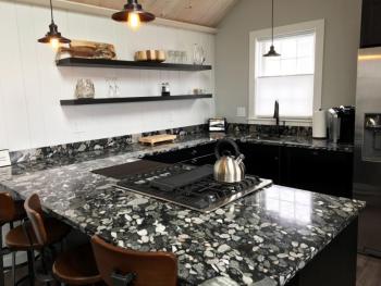 The kitchen area of this newly renovated suite at Topside Inn features a real riverbed countertop. SUZI THAYER/Boothbay Register