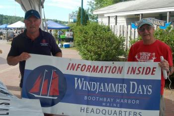 Mark Gimbel and Pete Ripley prepare to hoist the Windjammer Days banner. ART MAYERS/Boothbay Register