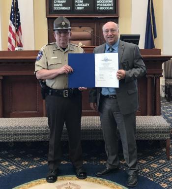Senator Dana Dow presents Deputy Clayton Jordan with a Legislative Sentiment on May 30. Courtesy photo