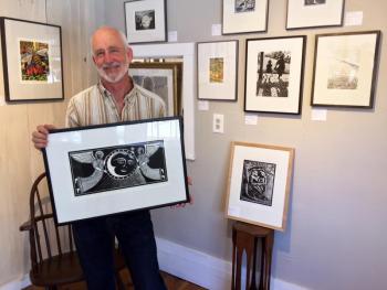 David Morgan holds one of his woodcut prints in his new gallery in Boothbay Harbor. SUZI THAYER/Boothbay Register