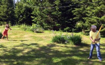 Pete and Sophia play home run derby in the back yard at the cottage, on the Fourth of July. SUZI THAYER/Boothbay Register