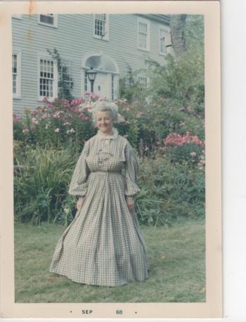 Birdene Webster Shackleton, in her period dress, stands outside the Nicholas Knight house in 1968. Birdene served as the greeter in the barn when visitors came to that first exhibit space. Courtesy of the Boothbay Region Historical Society