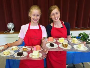 Erin Russell, left, and her sister Molly, serve cake at the Southport Country Fair and Lobster Roll Luncheon on July 19. SUZI THAYER/Boothbay Register