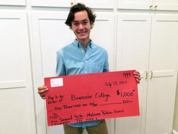 Sam Betts holds his “check” for $1,000, after receiving the Lincoln Arts Festival’s Annual Malama Robbins Scholarship Award. SUZI THAYER/Boothbay Register
