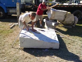Dan Ucci of Pittston (in red) is working with a large piece of Jonesboro Red from J.C. Stone. His project has become very collaborative with others pitching in including Andreas von Huene ( in yellow.) Margaret Hoffman photo Maine Coast Stone Symposium