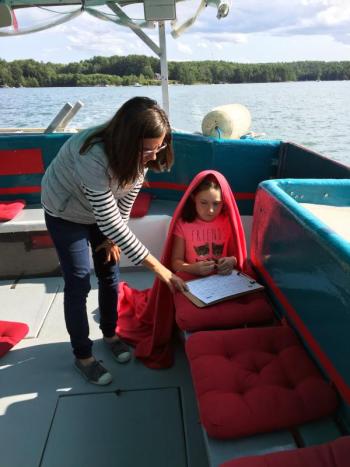 Olga Oros helps a passenger with a quiz offered for kids during the cruise. SUZI THAYER/Boothbay Register