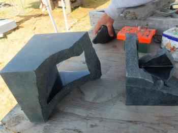 Kamu Nagasawa’s three-piece sculpture in progress. He’s reaching for the third piece that fits into the stone on the right. LISA KRISTOFF/Boothbay Register Kamu Nagasawa