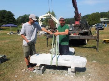 The pros prepare Lise Becu’s Sun woman for installation. Becu did the work on the two-piece sculpture, the other of the moon, with the granite in the supine position above. LISA KRISTOFF/Boothbay Register