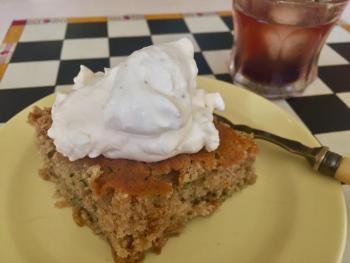 A piece of Foxtrot Cardamom Cake with whipped cream (with some fresh ground black pepper added) and a side of Basil Heyden’s bourbon with a few frozen blueberries and some cardamom simple syrup. SUZI THAYER/Boothbay Register