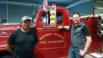 “Smoke alarms save lives. It’s that simple,” says Boothbay Harbor Fire Chief Nick Upham, left, pictured with Red Cross Disaster Program Manager Larry French. The Fire Department is among the organizations partnering with the American Red Cross of Maine to install free smoke alarms in homes on August 26.