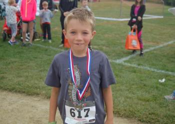 Ben Lewis receives his race medal. ART MAYERS/Boothbay Register