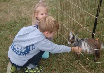 Bricken Sawyer and Boyn Yancy pet a baby goat. ART MAYERS/Boothbay Register