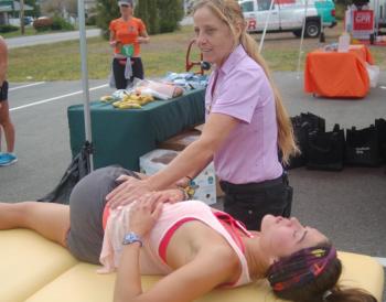 Runner Sara Lyons of Ellsworth gets a post-race massage from sports therapist Susan Peters of Newcastle. ART MAYERS/Boothbay Register