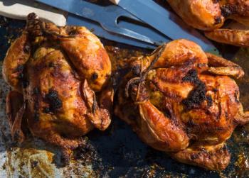 Two of Cherie Scott’s Garam Masala Cornish hens fresh out of the oven. Courtesy of Ted Axelrod Photography