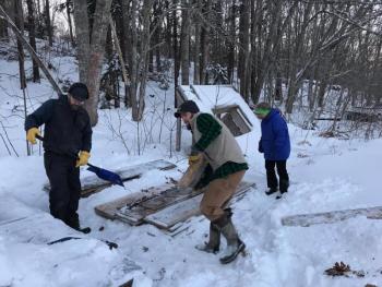 Kevin Anthony, far left, Wyatt Anthony and Jeanne Tonon help get the rink ready for the winter on Dec. 27. Courtesy of Mame Anthony