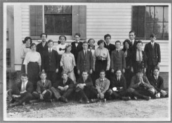 East Boothbay High School scholars in 1916. Left to right front row: ?, Claude Rice, Dwight VanHorn, ? Irving Adams, Elwin Whitehouse, ?, ?. Second row: Inez Gilpatrick, George Giles, Birdene Webster, Earl Fuller, Laura Jones, Carlos McKown, ?, Lawrence Farmer. Third row: Irma Reed, Richard Rice, ?, Shirley Race, Eleanor VanHorn, Roy Farmer, principal Mark Stinson, Everett Barlow. Courtesy of Lucy Marlowe, scholars mostly identified by Dot Rice Booth.