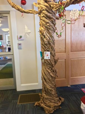 Joey Lane helped Scorcia turn a bare post in the children’s room into a tree. SUZI THAYER/Boothbay Register