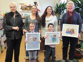 Artist Sue Heil Kibbe, far left, shares a Kodak moment with the kids in her “Santa Series” portraits completed two years ago and their family members. Front, from left: Lilly Brown and Hunter McDaniel; back, from left: Heil Kibbe, Cody Orne, Heather McDaniel and Sally Barter. LISA KRISTOFF/Boothbay Register