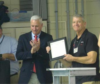 High school swim coach Don Strout is honored at the 2018 state meet. The Class A and Class B meets were dedicated to Strout for his 25 years of coaching and support of student athletes. Courtesy of Earl Brewer