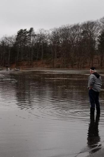Bob Gravino stands on a flooded road in Georgetown this March. The May 2 lecture focuses on ways that local communities can be prepared to deal with issues like coastal flooding and extreme storms. Kathy Gravino photo