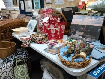 Services and items for the Boothbay Harbor Rotary Club’s annual Kentucky Derby party on May 5 arrive and are readied for the event’s silent auction. JANE CARPENTER/Boothbay Register