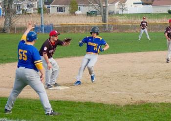 Coach Ed Crocker signals Fox Elder to stand up coming into third base. ART MAYERS/Boothbay Register