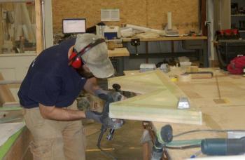 Andrew Follett polishes a tender support. ART MAYERS/Boothbay Register