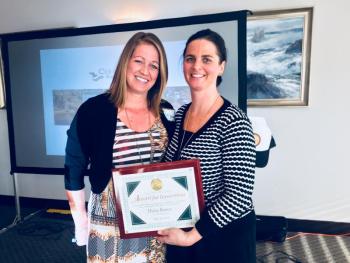 Haley Bezon, left, is awarded the first ever Annual Award for Innovation, by Coulombe Center Program Manager Anni Pat McKenney on May 21 at the Oceanside Gold Resort in Boothbay Harbor. SUZI THAYER/Boothbay Register