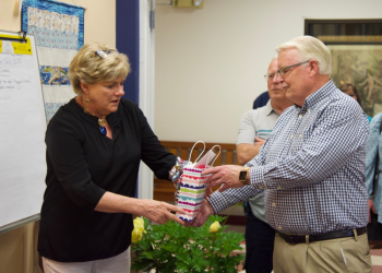 Jane Good receives a gift from Board of Directors President Shawn Lewin as Dwight Lewis, center right, looks on. Courtesy of Bob Crink