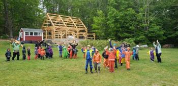 Juniper Hill School students and staff celebrate completion of the barn frame’s raising. Courtesy of Anne Stires/Juniper Hill School