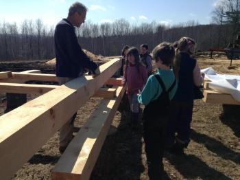 Kinne Stires discusses timber frame joinery with Juniper Hill kindergarten students. Courtesy of Anne Stires/Juniper Hill School