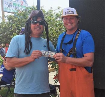 Sewall Maddocks Jr. is presented the winner’s $100 bill by contest co-organizer Chris Gleason. Then, Sewall returned the cash prize to the Friends of Windjammer Days to be used for future festivals. LISA KRISTOFF/Boothbay Register