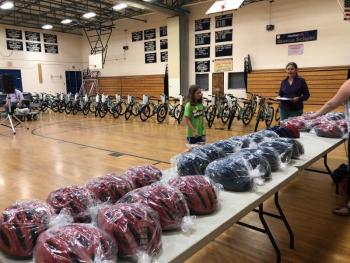 Meredith Ames, the top BRES reader, gets ready to choose a bicycle helmet during the assembly where participating students received bicycles and helmets from the Bay View Masonic Lodge for reading. PAGE BROWN/Boothbay Register