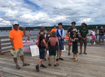 In 2017, Sheepscot River Race organizer Scott Shea, left, introduces the Camp Chewonki participants during the festivities after the race. Courtesy photo