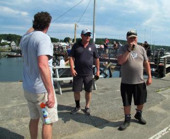 Tug coordinator Chris Gleason, far left, with Friends of Windjammer Days Secretary Mark Gimbel, center, and emcee Doug Gimbel at the 2018 tug. LISA KRISTOFF/Boothbay Register