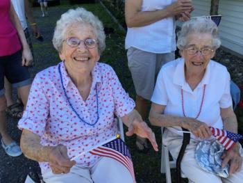 Fourth of July Parade honorees Evelyn Sherman, left, and Jean Thompson, sit in the shade before riding in Jim Singer’s convertible. ISABELLE CURTIS/Boothbay Register