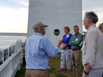 Jack Bauman, left, talks to attendees about the history of the lighthouse. Courtesy of Elaine Jones