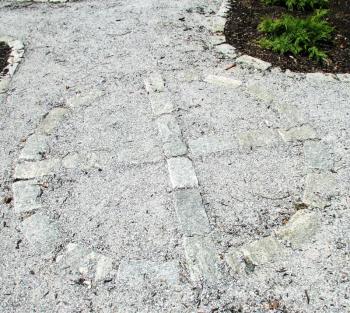 This cobblestone design marks the point where the paths intersect in the Meditation Garden, LISA KRISTOFF/Boothbay Register