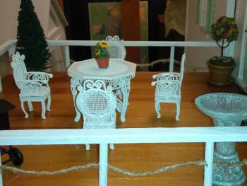 The rooftop terrace includes a birdbath, Victorian furniture and a topiary. JANE CARPENTER/Boothbay Register