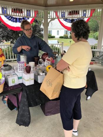 One of the vendors at the fundraiser tends to a customer. KELLIE BIGOS/Boothbay Register